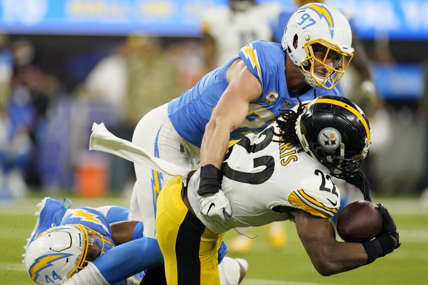 Los Angeles Chargers defensive end Joey Bosa (97) tackles Pittsburgh Steelers running back Najee Harris.