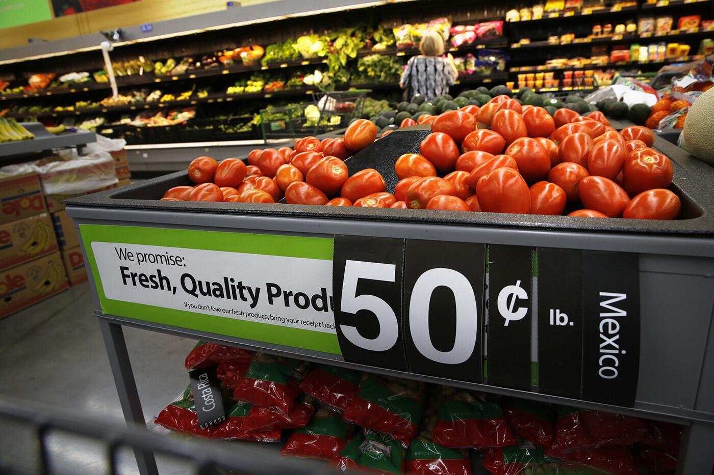 Roma tomatoes from Mexico on display in the produce section of a Wal-Mart store in San Marcos, Calif. The corporation sets stringent standards to ensure "fresh, quality produce" for its retail customers -- but health, and housing conditions for the people who pick the fruit on Mexican farms were found to be deplorable.