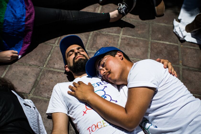 Noah Reich, left, and Dave Maldonado take part in a "die-in" at Los Angeles City Hall to protest gun violence in America.