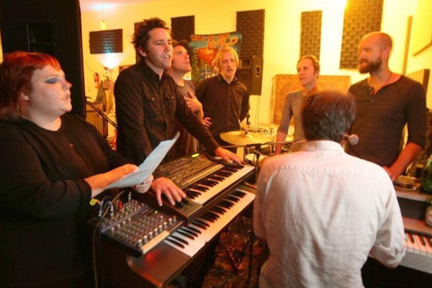 Members of the L.A. band the Afternoons -- from left, Claire McKeown, Steven Scott, Brian Canning, Tom Biller, Brent Turner, Sam Johnson and Aaron Burrows at the keyboards -- practice in the studio. They're changing the band's name to Shadow Shadow Shade to avoid being confused with other bands on Google searches.