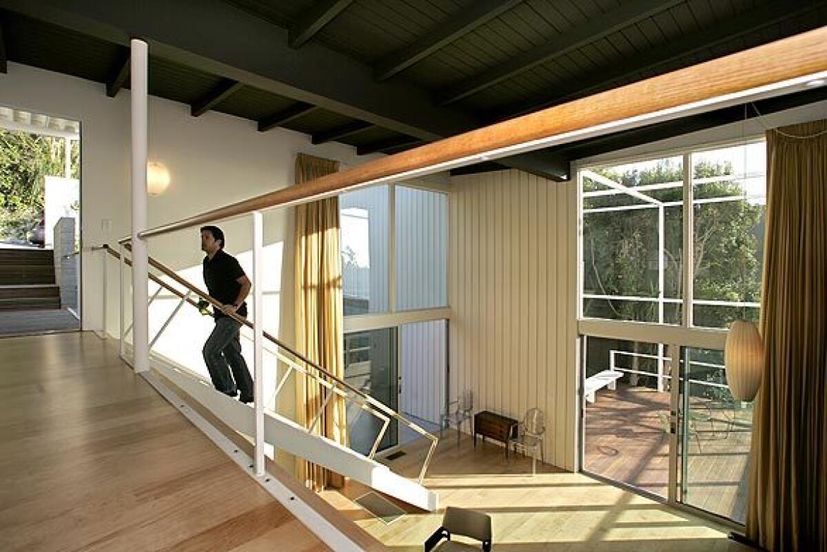 Restoration architect Aaron Torrence of Design Plus Construction climbs the stairs at the renovated Pasinetti house. The Beverly Hills home was built in 1958 by architect Haralamb Georgescu. Renowned in his native Romania, Georgescu (1908-77) designed dozens of buildings in Southern California, but never gained the same level of fame here as his midcentury contemporaries. Before he fled Communist rule and immigrated to the U.S. in 1947, Georgescu had a successful career; today many of his modernist buildings in Bucharest are landmarks. His Pasinetti house was featured in the influential Arts & Architecture magazine 50 years ago, but the house fell into obscurity until real estate developer Tim Braseth of Willow Glen Partners came upon the property in 2007. Torrence was called in to help with the restoration of the home, which takes its name from its first owner, Italian writer Pier Maria Pasinetti (1913-2006), who taught Italian and comparative literature at UCLA.