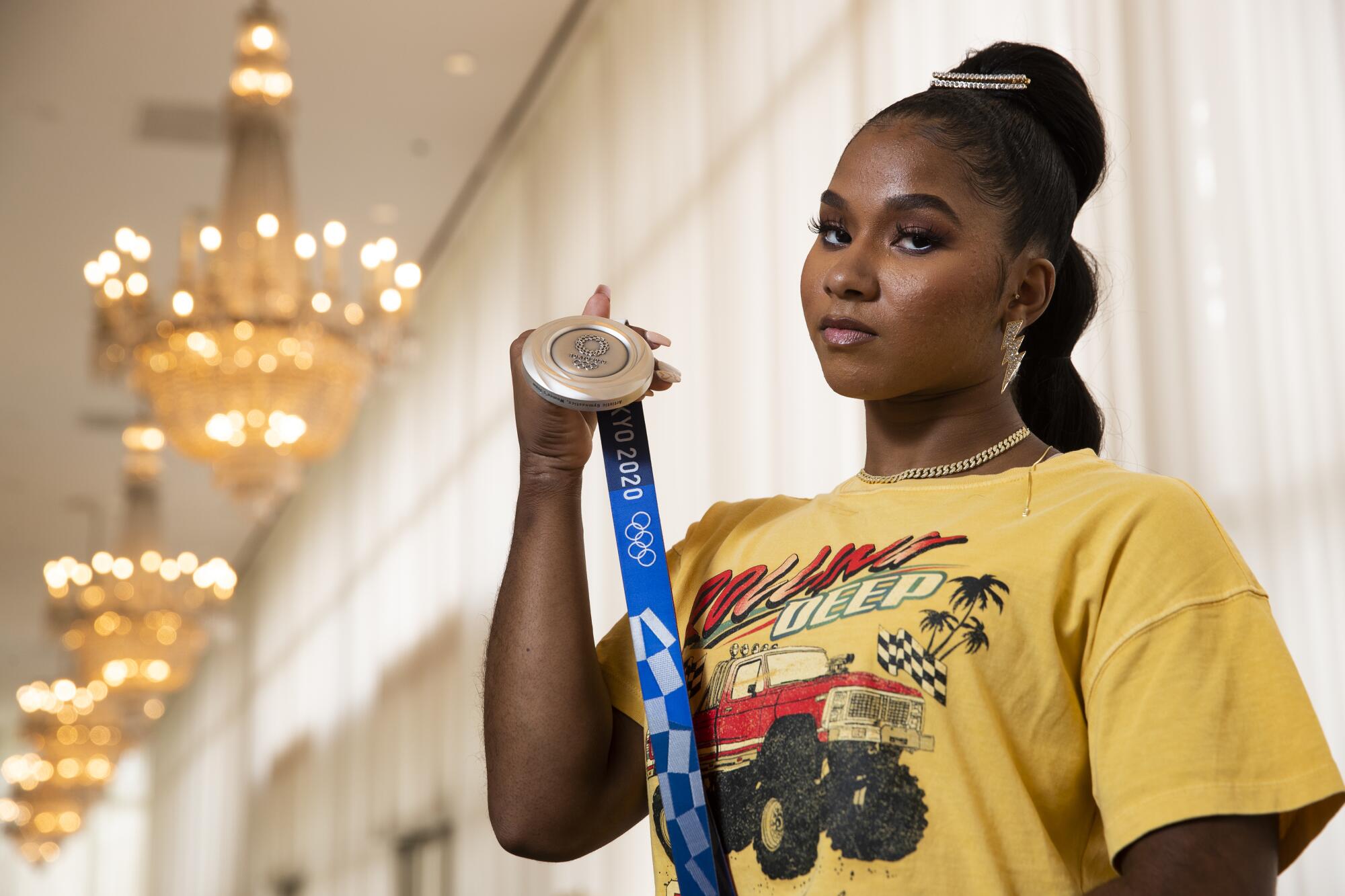 UCLA gymnast Jordan Chiles holds the Olympic silver medal she won at the Tokyo Olympics in 2021.