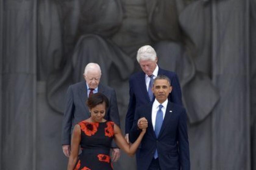 President Obama escorts First Lady Michelle Obama with former presidents Jimmy Carter and Bill Clinton during ceremonies at the Lincoln Memorial marking the 50th anniversary of the March on Washington.