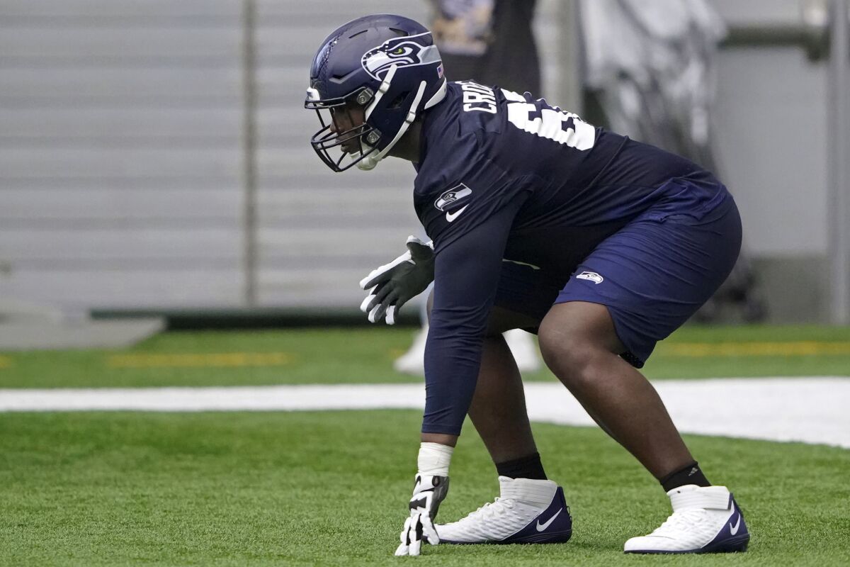 Seattle Seahawks offensive tackle Charles Cross gets set in a three-point stance during NFL football rookie minicamp Friday, May 6, 2022, in Renton, Wash. (AP Photo/Ted S. Warren)