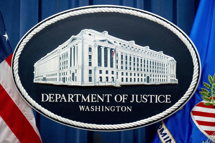 FILE - A U.S. Department of Justice sign is seen, Nov. 18, 2022, in Washington. The U.S. Justice Department says a former CIA employee and senior official at the National Security Council has been charged with serving as a secret agent for South Korea’s intelligence service. (AP Photo/Andrew Harnik, File)