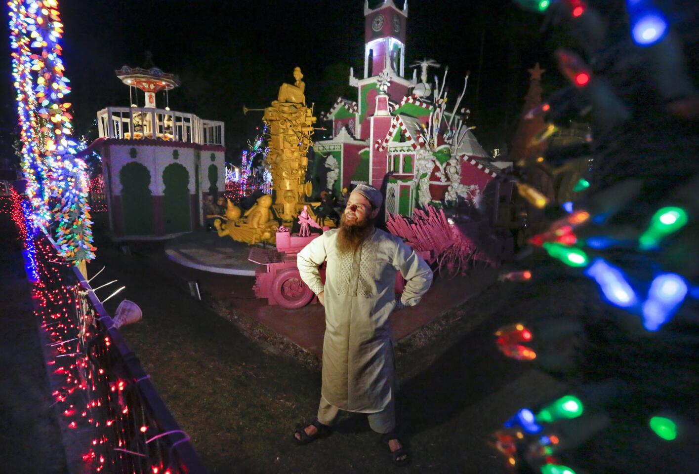 Artist Kenny Irwin Jr. checks the lights in front of the Candy Cane Palace area of his elaborate and quirky Robolights display in Palm Springs.