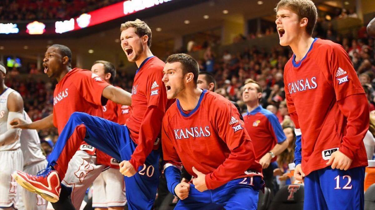 Players on the Kansas bench can't contain their excitement after the Jayhawks scored a late basket during Saturday's game against Texas Tech. The Jayhawks won, 80-79.