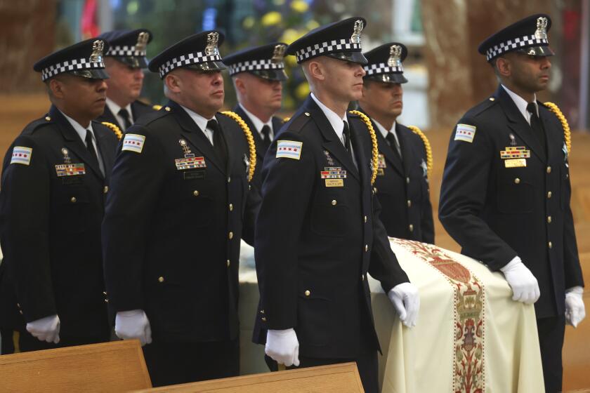 Pallbearers bring in the casket of Chicago police officer Luis M. Huesca for his funeral at St. Rita of Cascia Shrine Chapel in Chicago, Monday, April 29, 2024. Huesca was shot to death while off-duty and heading home from work. (Antonio Perez/Chicago Tribune via AP, Pool)