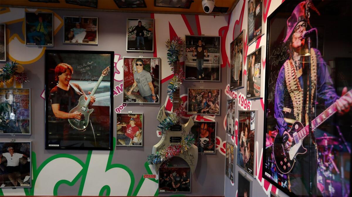Signed photographs of musicians and celebrities adorn the walls at Archie's Ice Cream in Tustin.