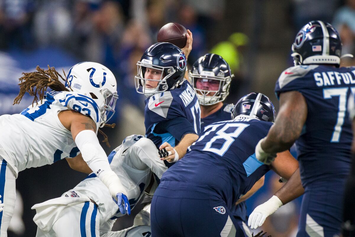 Tennessee Titans quarterback Ryan Tannehill looks to pass as he is sacked by Indianapolis Colts linebacker Anthony Walker.