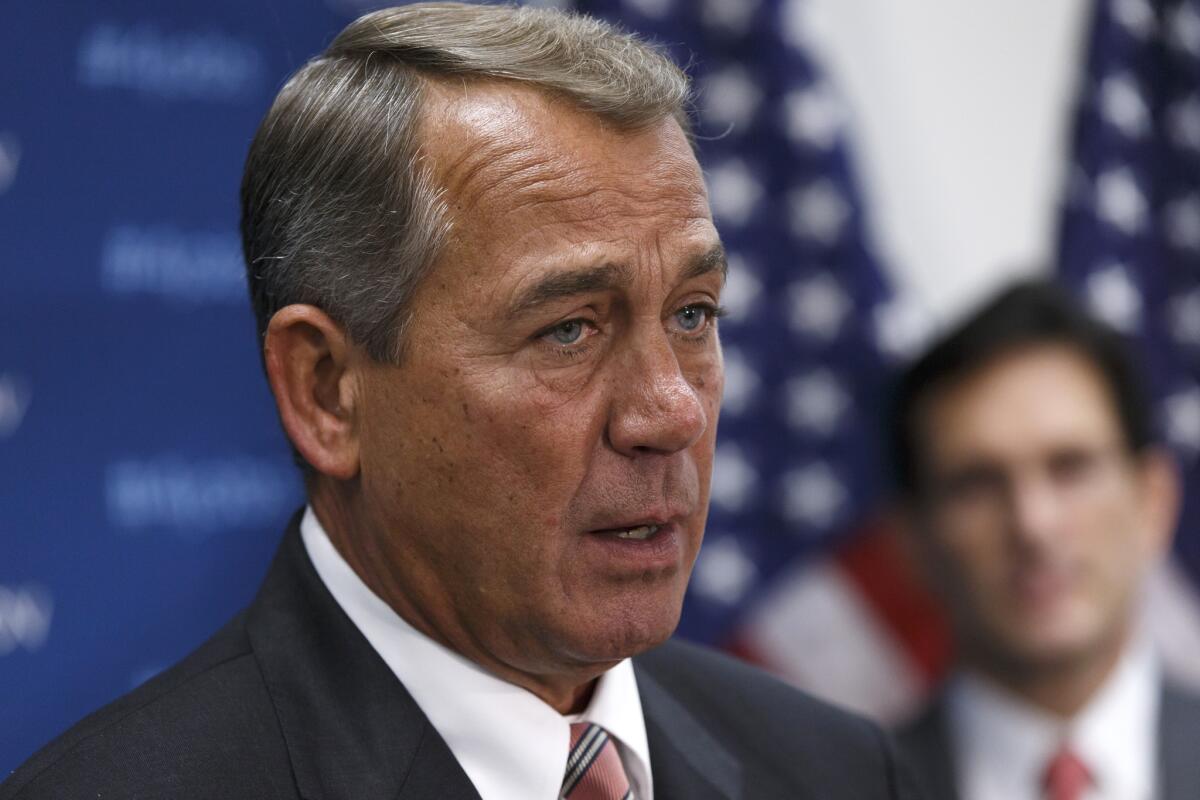 House Speaker John A. Boehner (R-Ohio) meets with reporters after a Republican caucus on Capitol Hill.