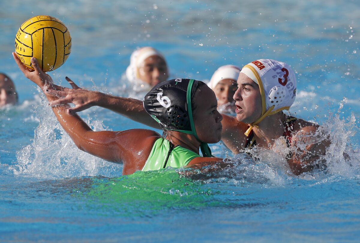 Costa Mesa's Ta’iuta Uiagalelei (6) is being defended by Estancia's Cassie Corrigan (3) in an Orange Coast League match on Feb. 5.