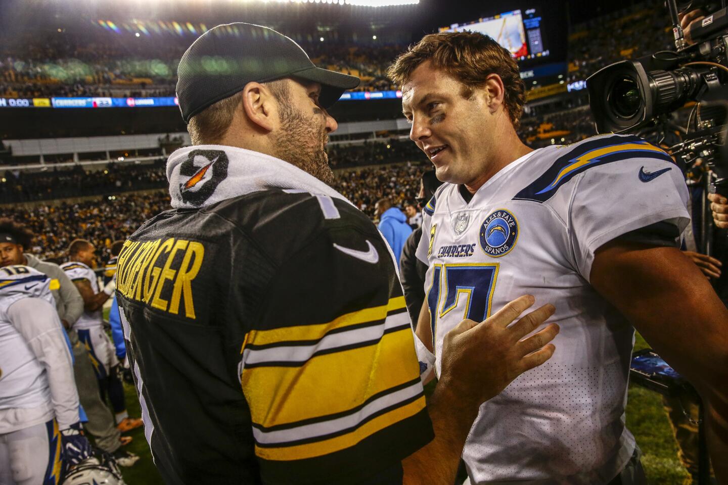 Ben Roehtlisberger and Philip Rivers meet up at the 50-yard line after a 33-30 win.