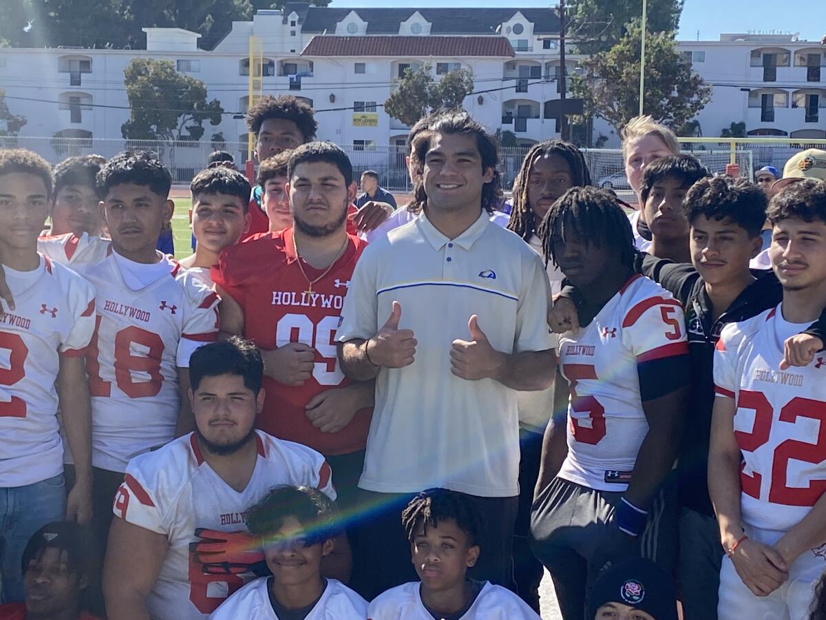 Rams rookie receiver Puka Nacua shows thumbs up during a meeting with the  Hollywood High football team.