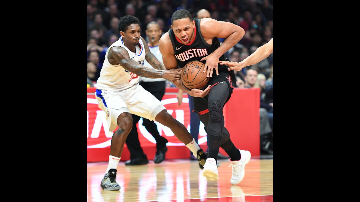 Houston Rockets' Eric Gordon, right, is fouled by Clippers' Lou Willams as he drives to the basket in the fourth quarter.