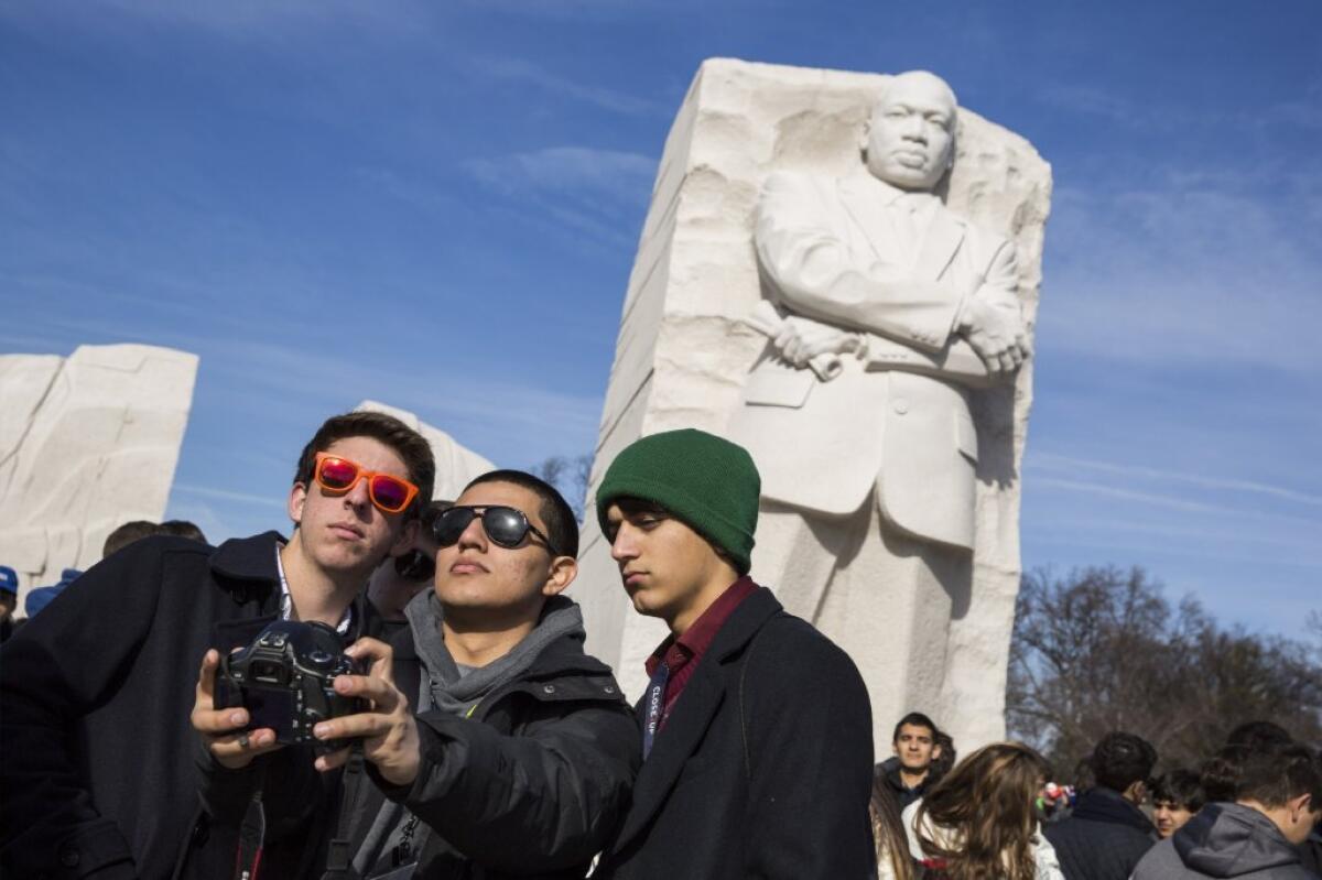 High school students from Louisiana take a photo at the Martin Luther King Jr. Memorial on Monday.