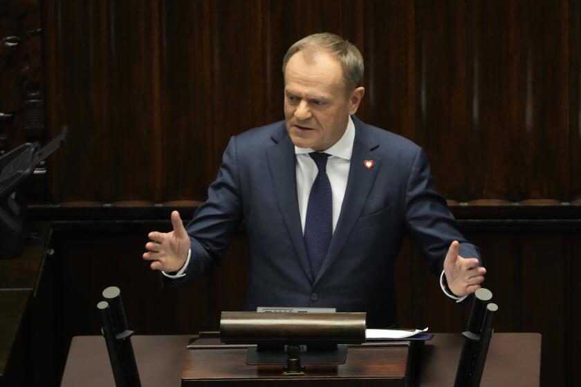 Newly elected Poland's Prime Minister Donald Tusk addresses lawmakers during his speech at the parliament in Warsaw, Poland, Tuesday Dec. 12, 2023. (AP Photo/Czarek Sokolowski)