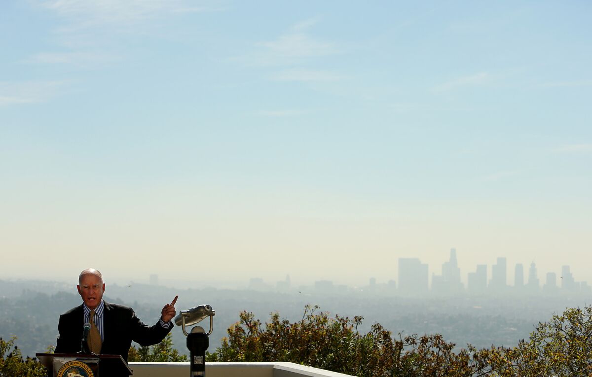 Gov. Jerry Brown, shown at the Griffith Observatory last year, signed new climate legislation in a Los Angeles park on Thursday.
