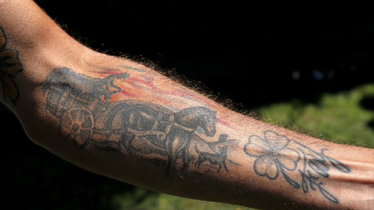 Galaxy midfielder Baggio Husidic has a tattoo that depicts his grandfather driving a hay wagon alongside the family dog in Bosnia.