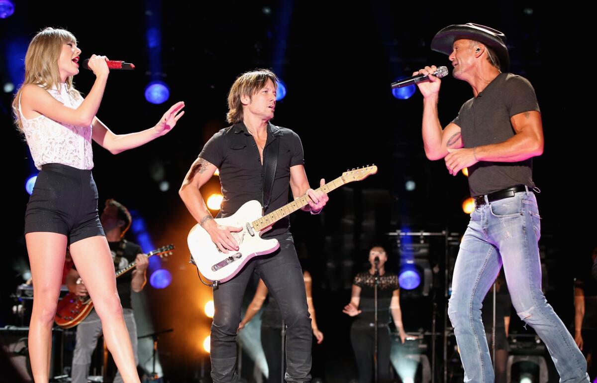 Taylor Swift, Keith Urban and Tim McGraw perform during the 2013 CMA Music Festival on June 6, 2013 in Nashville, Tennessee.