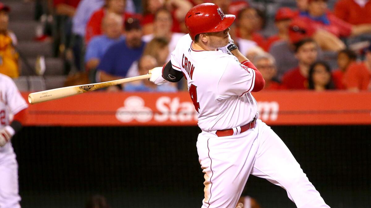Angels slugger C.J. Cron follows through on a solo home run in the eighth inning against Astros on Saturday night in Anaheim.