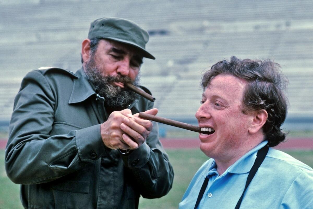 Photographer Leifer getting a light from Fidel Castro in an undated image from "Relentless." (Neil Leifer)