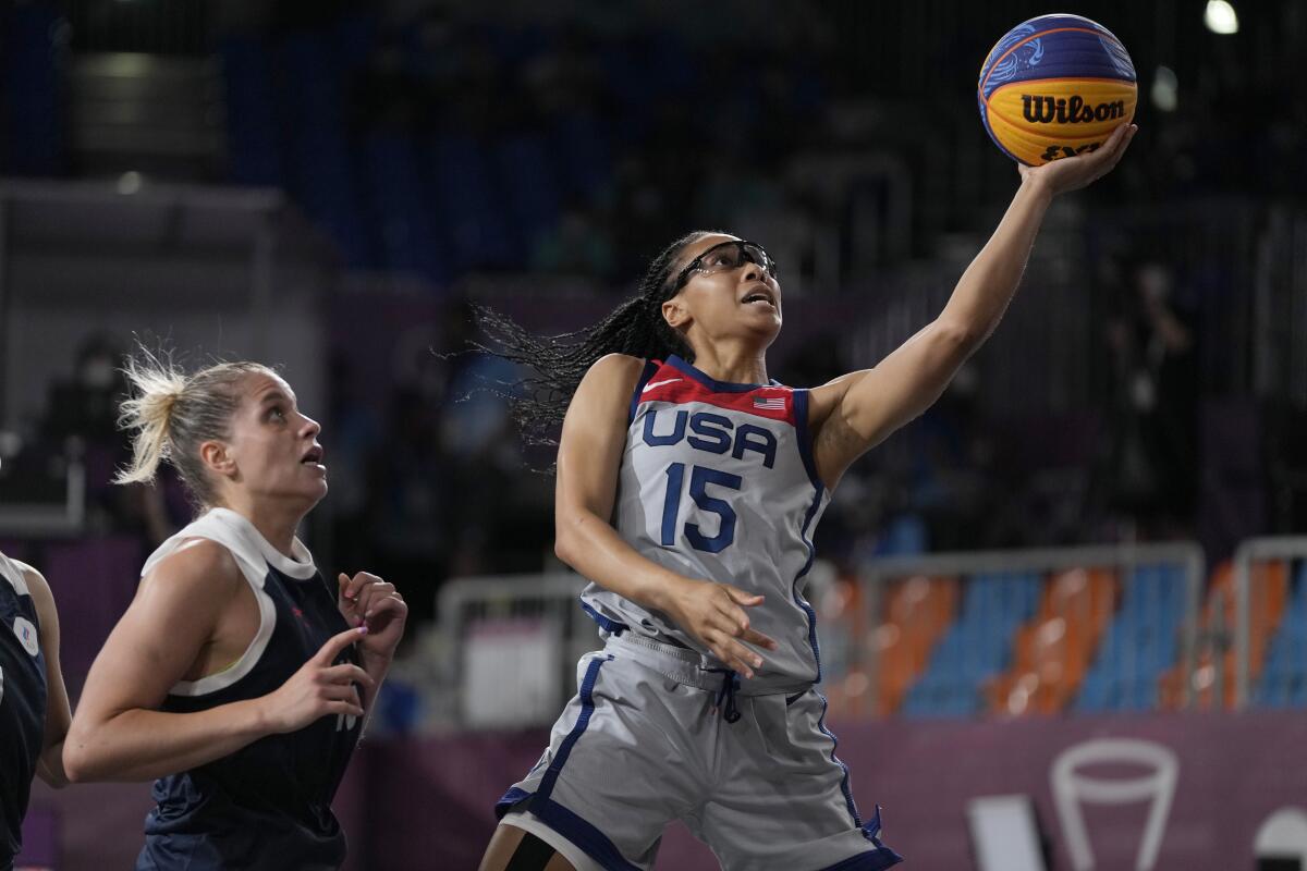 Allisha Gray of the U.S. heads to the basket past Evgeniia Frolkina of the Russian Olympic Committee team