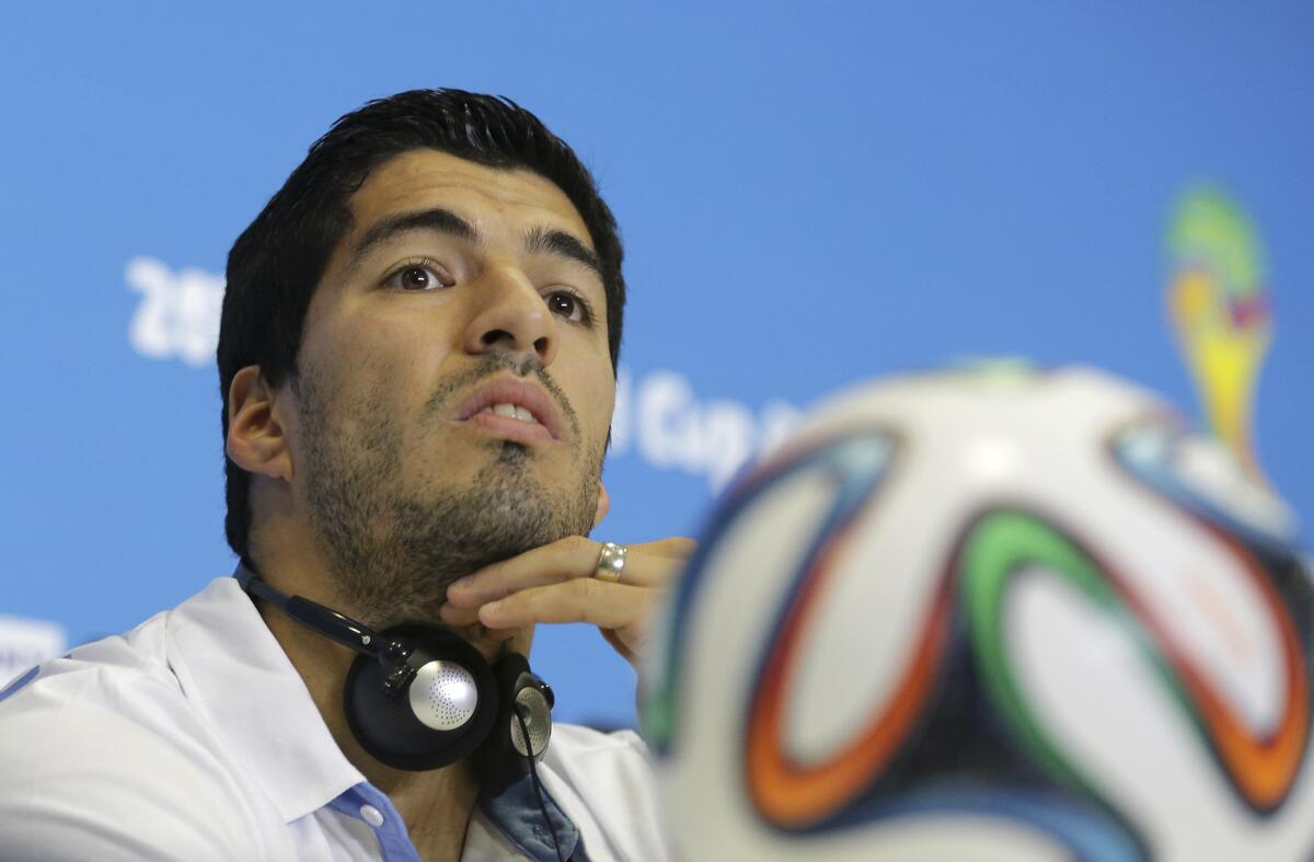 Uruguay's Luis Suarez listens to a question during a news conference on June 23.