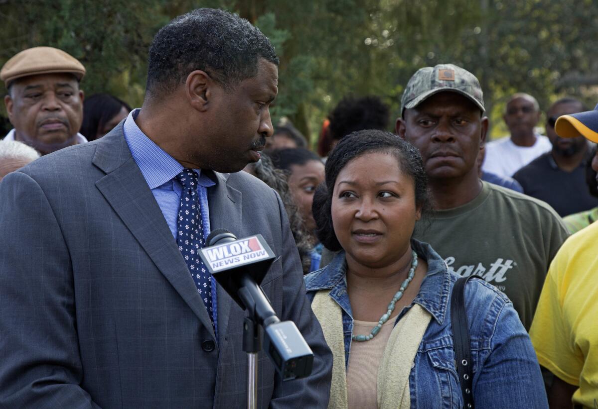 Derrick Johnson, left, president of the Mississippi NAACP, in front of the Stone County Courthouse in Wiggins, Miss., on Monday with parents of a high school football player who was allegedly the victim of hate crime.