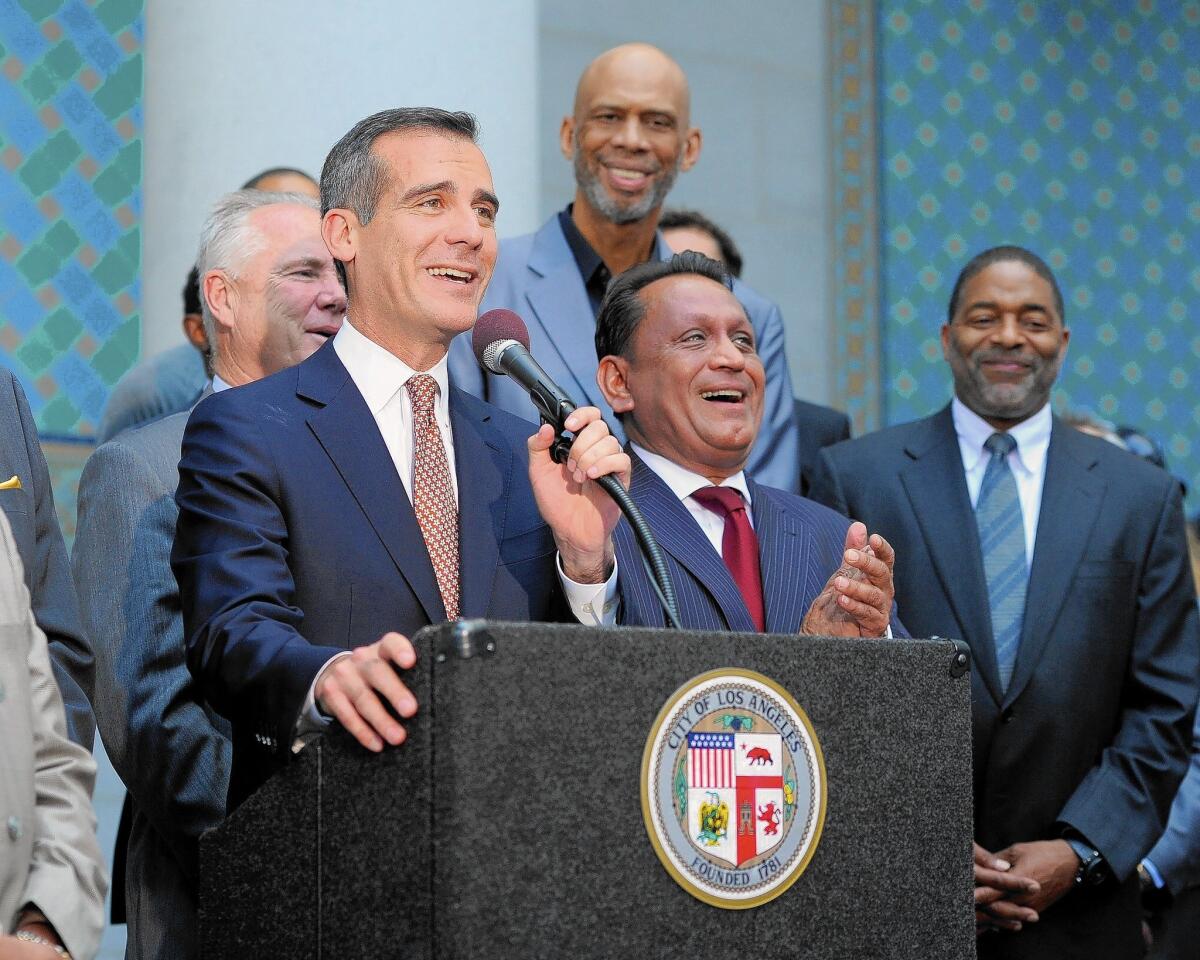 At a news conference outside L.A. City Hall, Mayor Eric Garcetti, at microphone, Kareem Abdul-Jabbar, Councilman Gilbert Cedillo and former Laker Norm Nixon address the media regarding Donald Sterling's ownership of the Clippers.