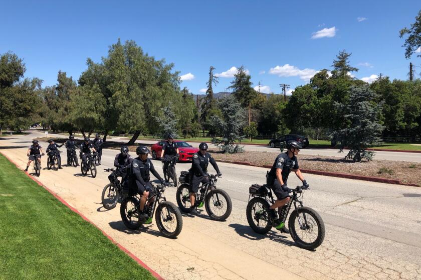 LAPD officers patrol Griffith Park by bike on Thursday afternoon.