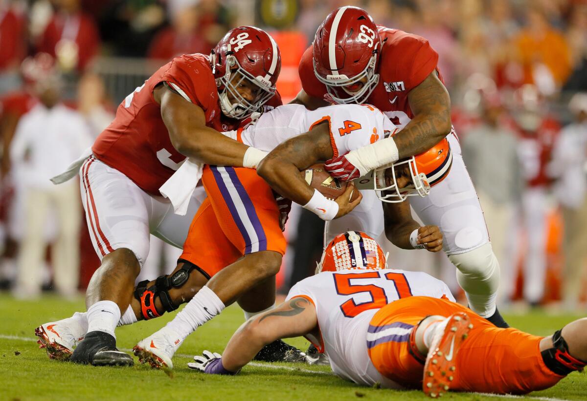 Alabama defensive linemen Da'Ron Payne (94) and Jonathan Allen (93) tackle Clemson quarterback Deshaun Watson during the first quarter Monday.