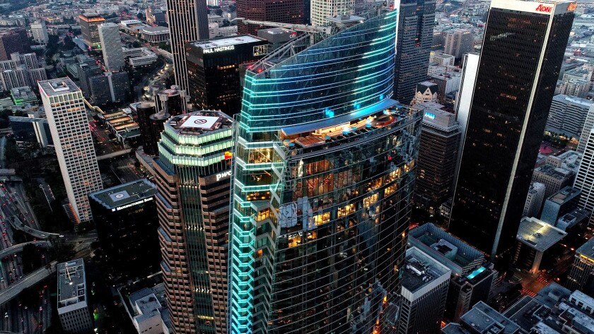 The Wilshire Grand Center in downtown Los Angeles is seen illuminated at dusk.