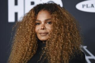 Janet Jackson poses with voluminous ginger-toned hair at the 2019 Rock & Roll Hall of Fame induction ceremony in New York