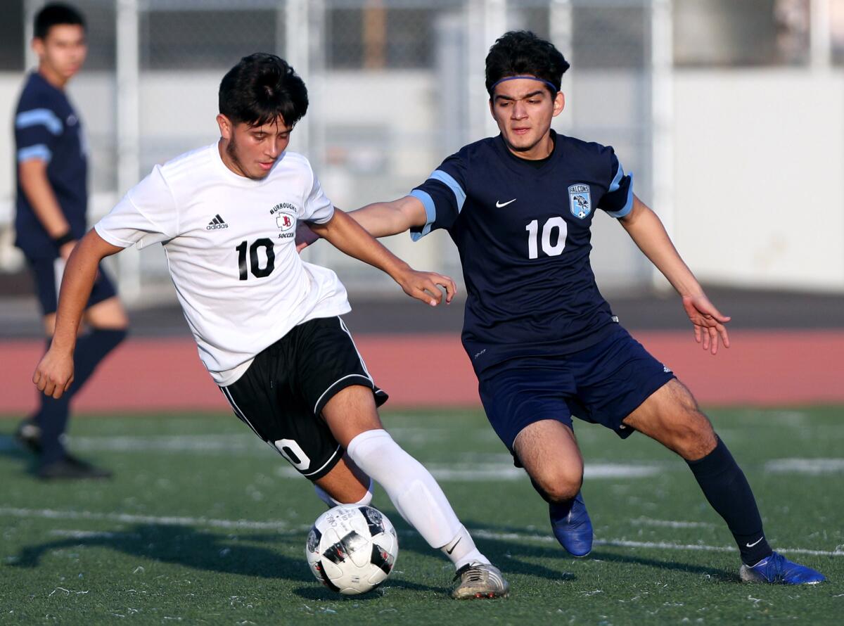 Burroughs Juan Carlos Rosales, left, controls the ball as Alejandro Vela-Rodriguez chases in game at Crescenta Valley High in La Crescenta on Friday, Dec. 13, 2019.