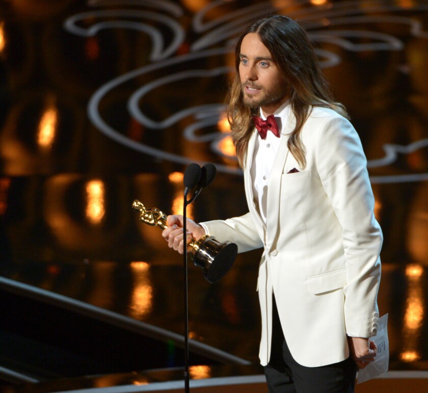 Jared Leto stands at microphone