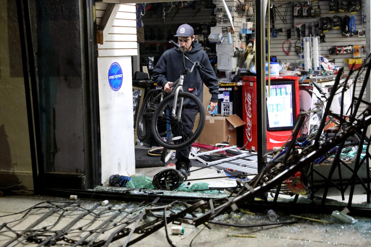 Looters and vandals ransack Spokes 'N Stuff at Melrose Avenue and Ogden Drive on Saturday.