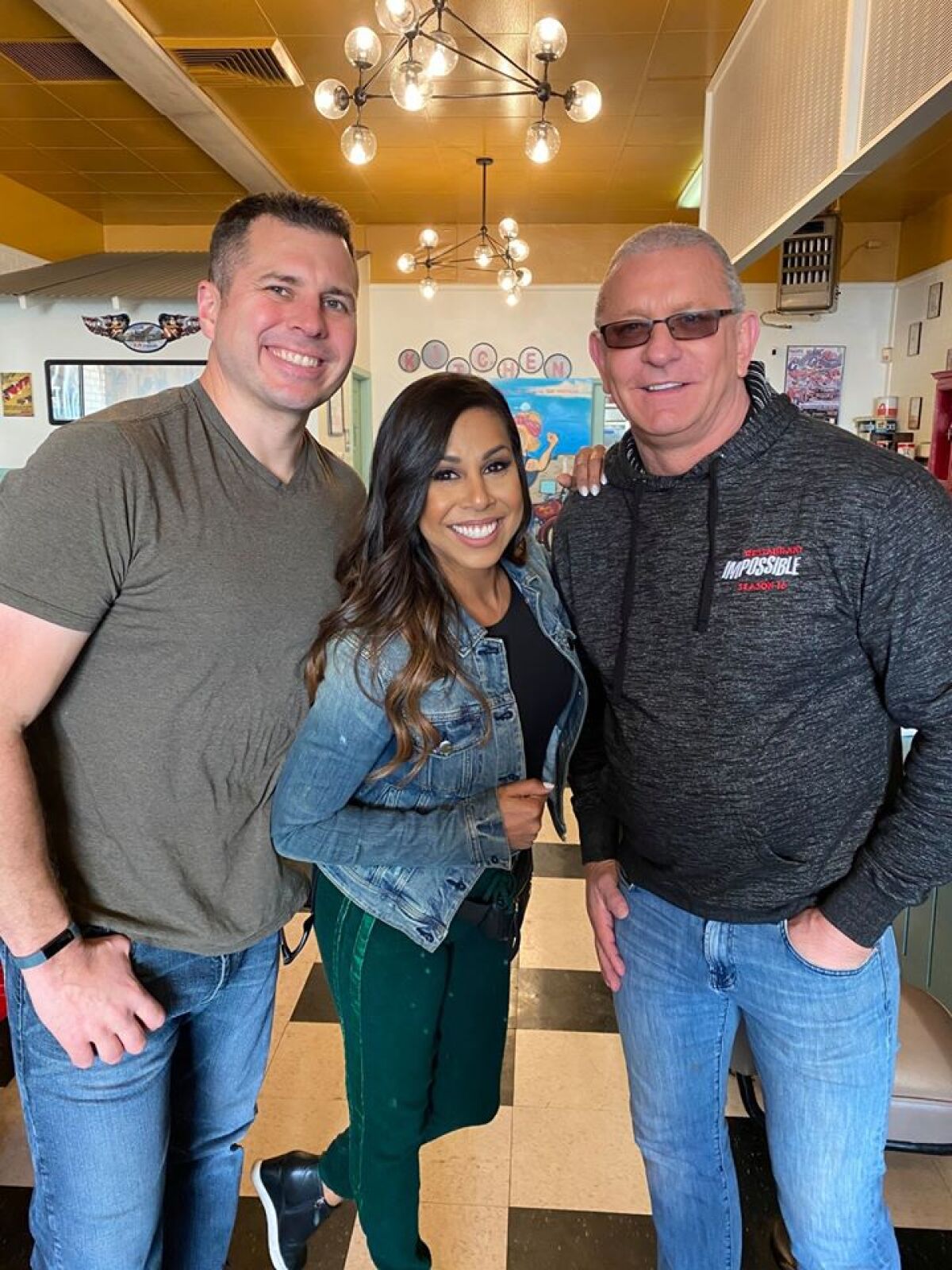 "Restaurant: Impossible" castmates Tom Bury, left, Taniya Nayak and Robert Irvine photographed inside Rosie's Cafe in Escondido during a fundraising carnival on Feb. 17 to benefit cafe owner Kaitlyn Pilsbury, who was injured Dec. 21 in a hit-and-run accident.