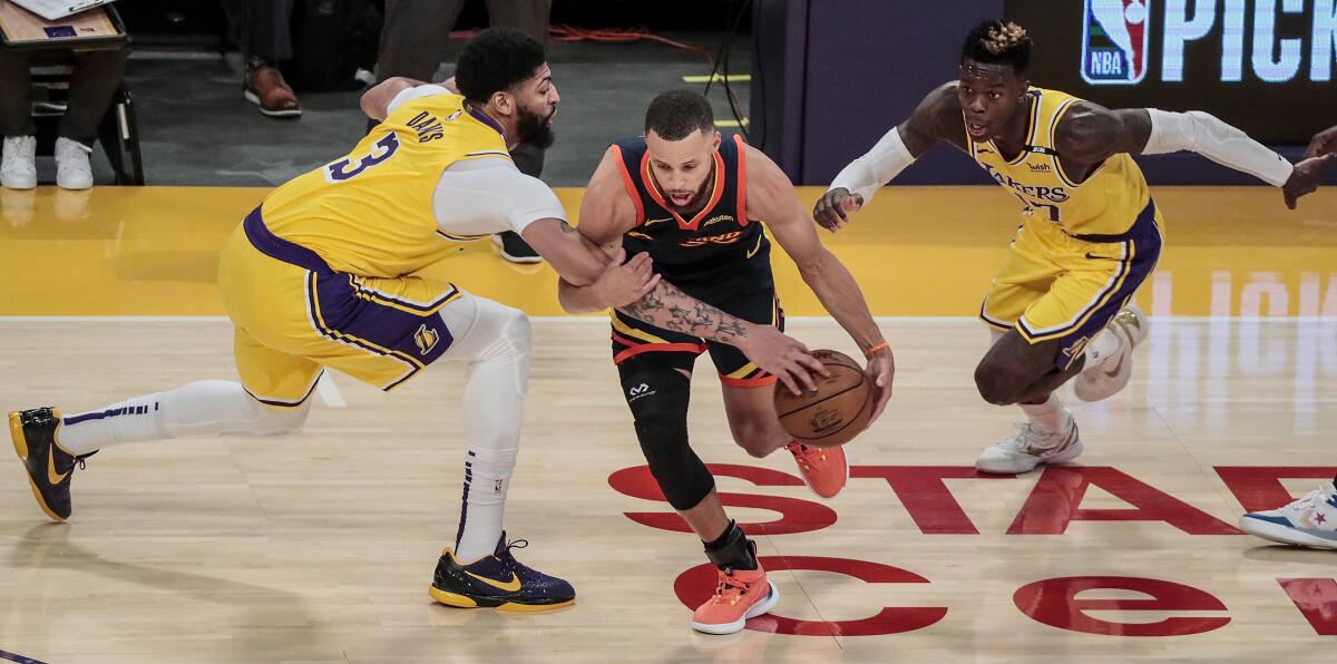 Los Angeles Lakers forward Anthony Davis (3) fouls Golden State Warriors guard Stephen Curry.