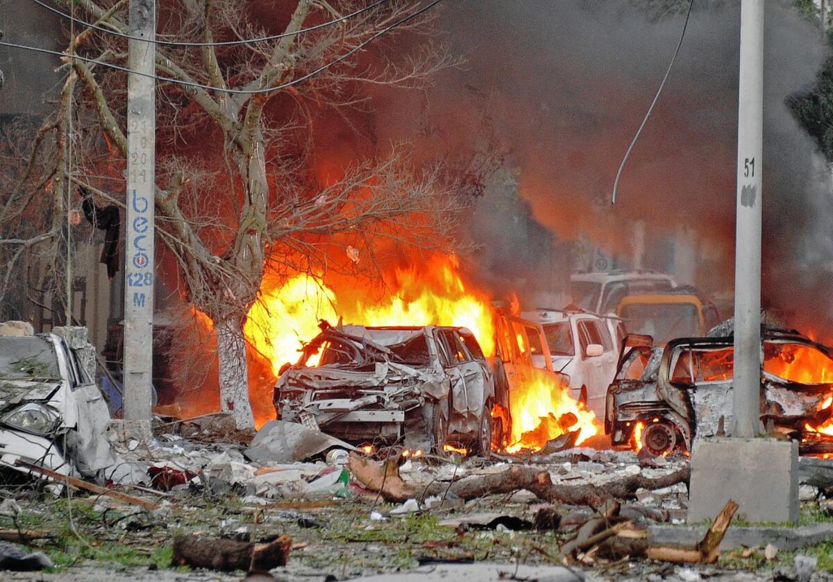 Wreckage burns at the scene of a terrorist attack at the Ambassador Hotel in Mogadishu, Somalia, after a car bomb exploded on Wednesday.