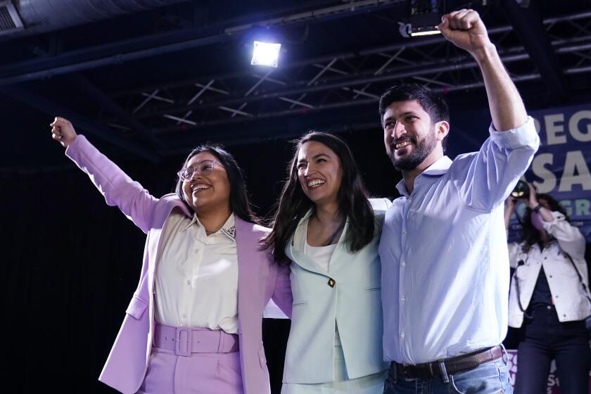 U.S. Rep. Alexandria Ocasio-Cortez, center, joins a rally for Democratic Congressional candidates Jessica Cisneros, left, and Greg Casar, right, Saturday, Feb. 12, 2022, in San Antonio. (AP Photo/Eric Gay)