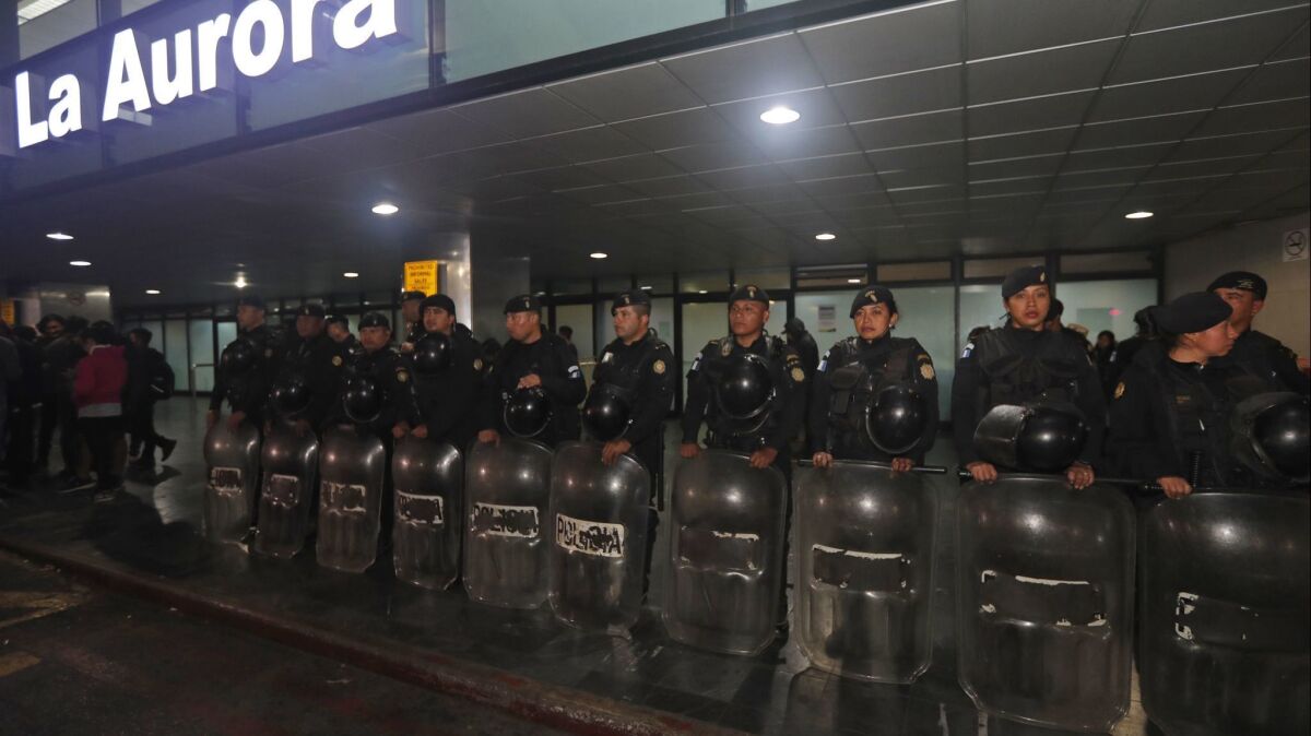 Anti-riot police stand guard at La Aurora International Airport in Guatemala City, where the Guatemalan government banned the entry Saturday of Yilen Osorio, an official with a U.N.-backed anti-corruption commission. After a court order, Osorio was released Sunday.