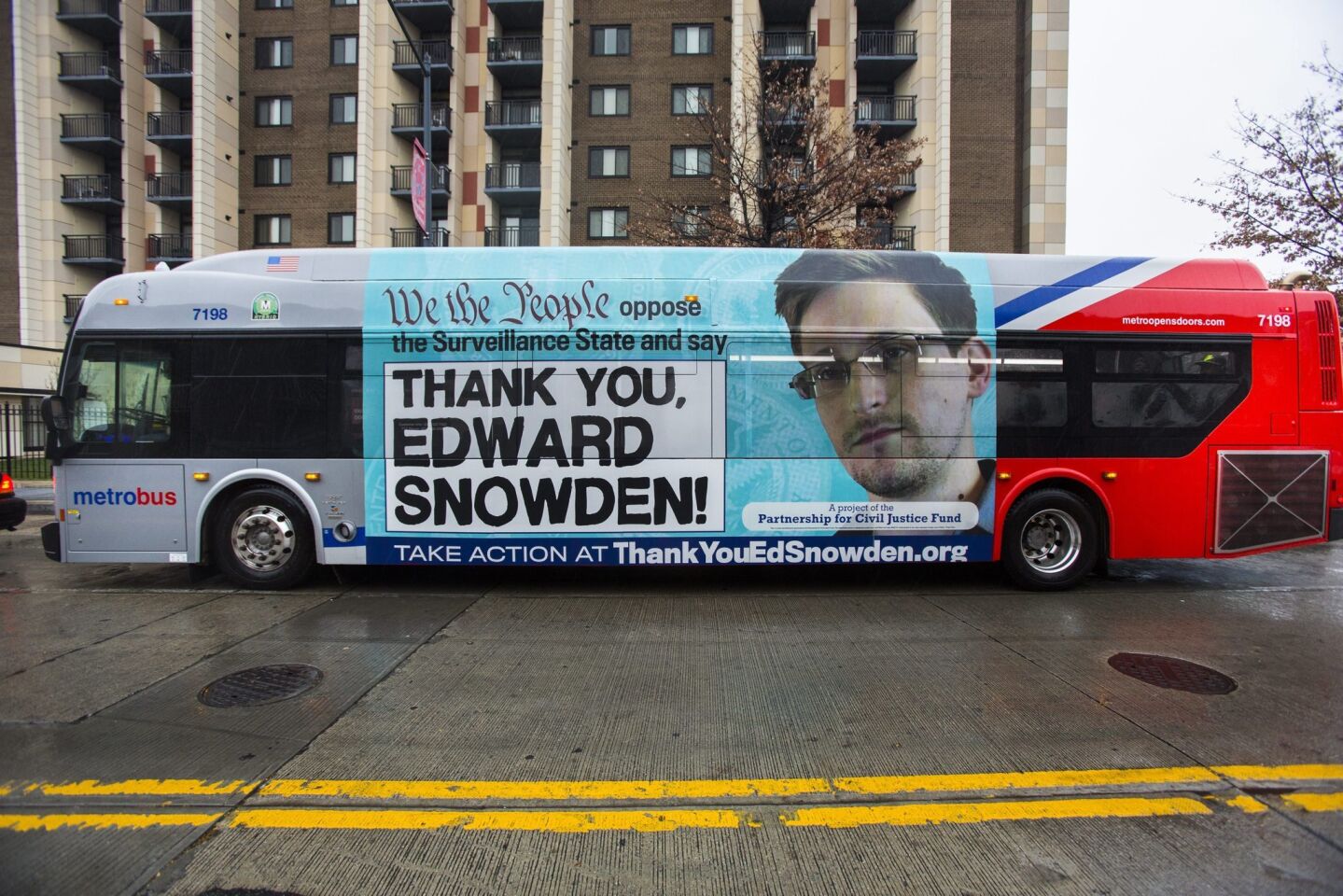 An advertisement thanking leaker Edward Snowden appears on the side of a Metrobus in downtown Washington, D.C.