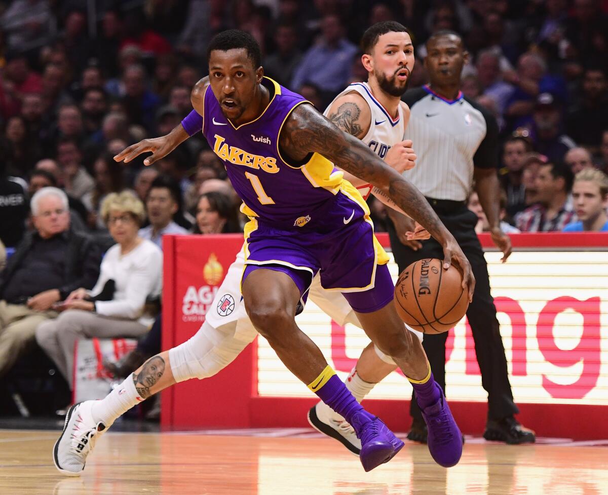 LOS ANGELES, CA - NOVEMBER 27: Kentavious Caldwell-Pope #1 of the Los Angeles Lakers drives to the basket past Austin Rivers #25 of the LA Clippers during the first quarter in a 120-115 LA Clipper win at Staples Center on November 27, 2017 in Los Angeles, California.