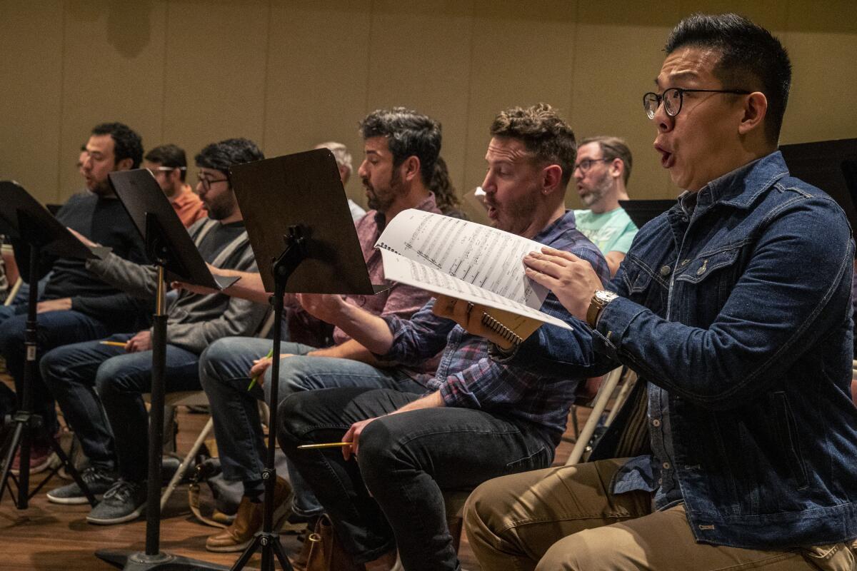 Ben Lin, right, sings bass with the Los Angeles Master Chorale as the group rehearses “Sunrise: A Song of Two Humans."