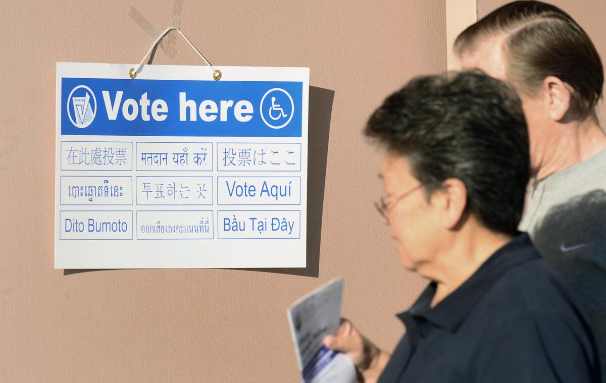Signs in various languages direct voters to polling stations at the Alhambra Fire Station #71 in Los Angeles County.