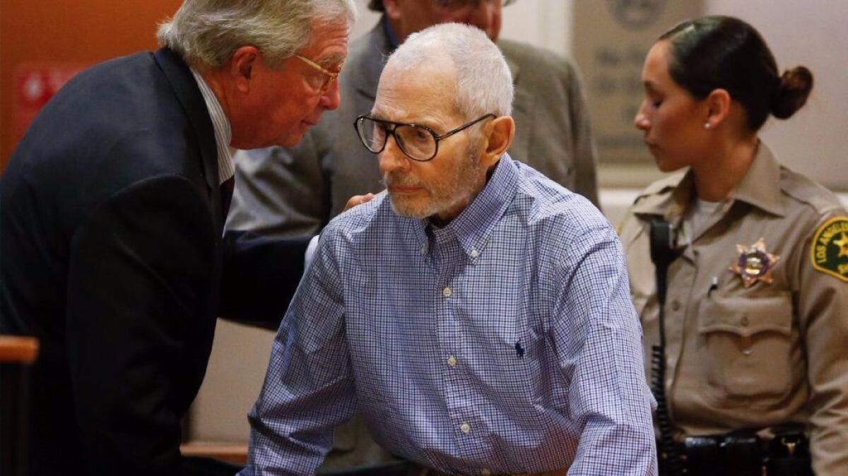 New York real estate scion Robert Durst, center, speaks with his attorney, Dick DeGuerin, at a previous court hearing. Durst appeared in a Los Angeles court this week for a hearing in his murder case.