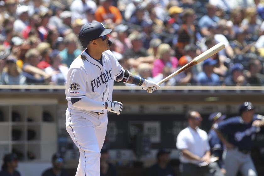 The Padres' Manny Machado watches his hit to the fence that looked like it was a three-run home run, but further review ruled otherwise in the second inning against the Brewers at Petco Park in San Diego on Wednesday, June 19, 2019 in San Diego, California.