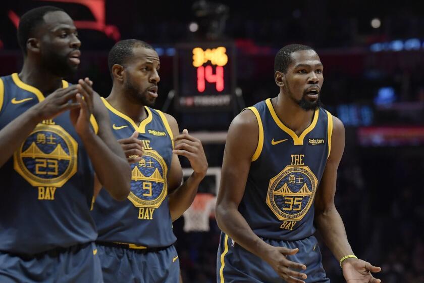 Golden State Warriors forward Kevin Durant, right, reacts as he fouls out of the game while forward Draymond Green, left, and guard Andre Iguodala look on during the overtime portion of an NBA basketball game against the Los Angeles Clippers Monday, Nov. 12, 2018, in Los Angeles. The Clippers won 121-116 in overtime. (AP Photo/Mark J. Terrill)
