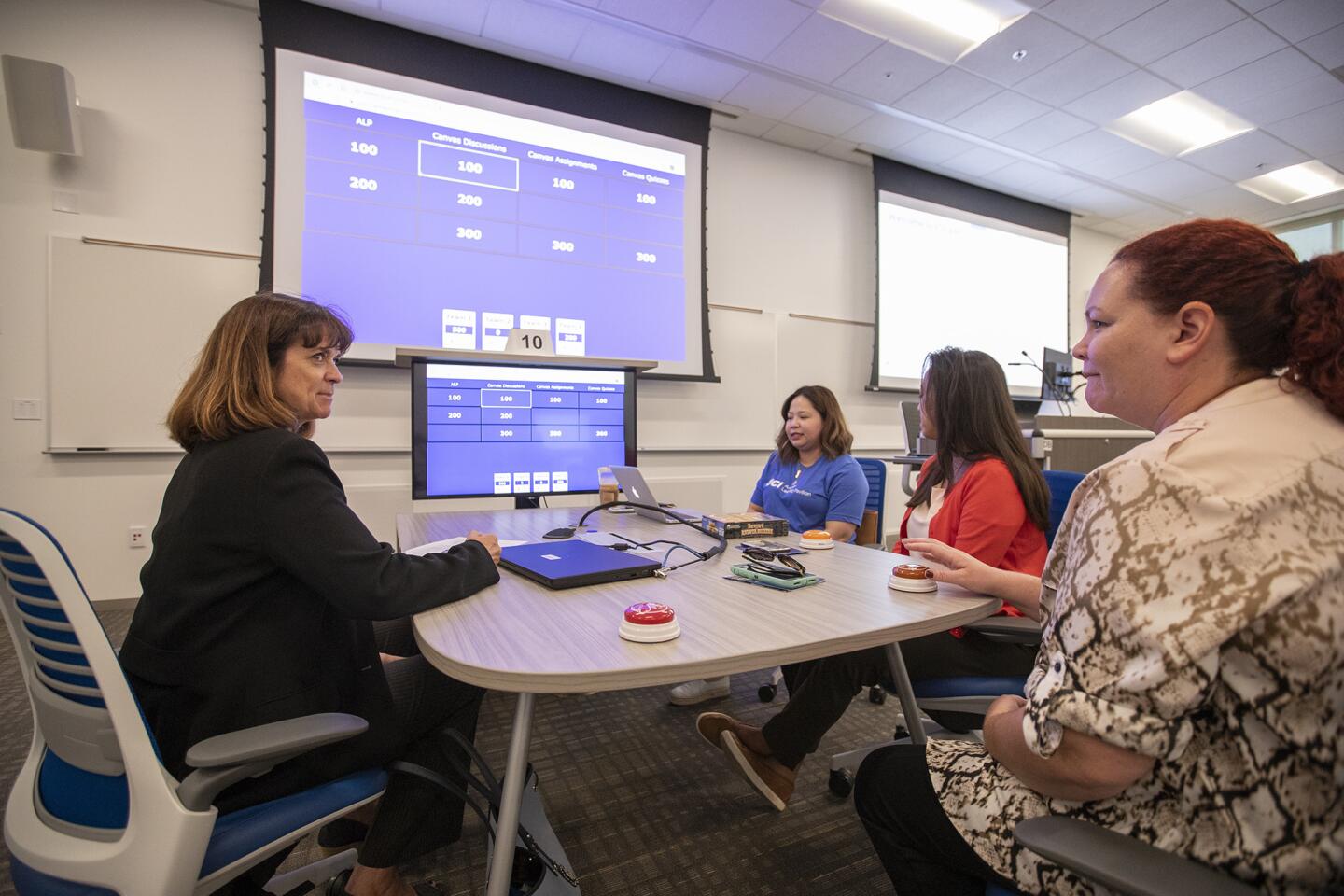 People use the Canvas Learning Management System to play "Jeopardy" in an "active learning" classroom at the new Anteater Learning Pavilion on Tuesday.